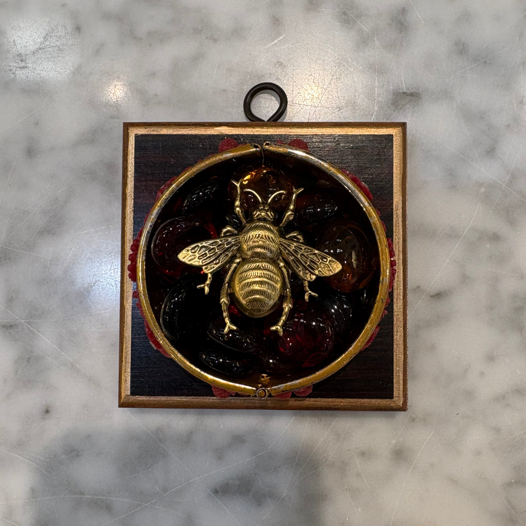 Museum Bees - Gold Bee on top of red stones in a red bracelet